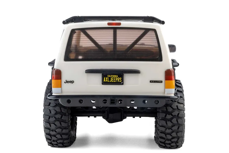 Rear view of the white Axial SCX10 III Jeep Cherokee XJ RC rock crawler showing scale detail, license plate, and off-road tyres.