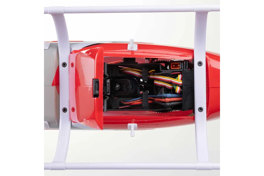 Top-down view of the internal chassis and wiring inside the red and white fuselage of the Blade Jet Ranger RC helicopter.