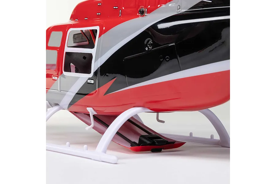 Close-up of the red, black, and silver painted fuselage and white landing skids of the Blade Jet Ranger 235CP RC helicopter.