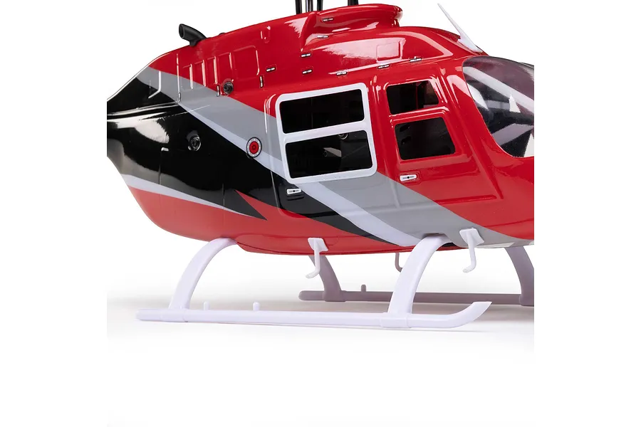 Close-up studio shot of the red, black, and white fuselage and landing skids of the Blade Jet Ranger 235CP RC helicopter.