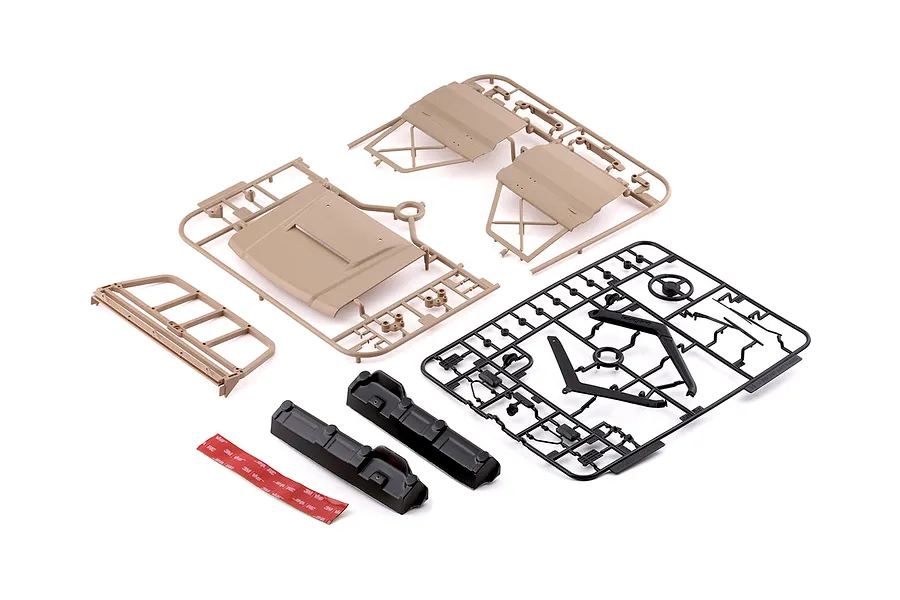 Killerbody 1/10 Toyota Land Cruiser 70 hard body kit parts laid out on a white background, including desert yellow panels and black detail sprues.