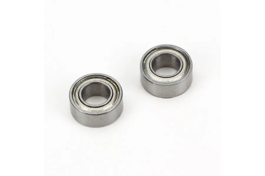 Two metal shielded ball bearings shown on a plain white background in a studio setting.