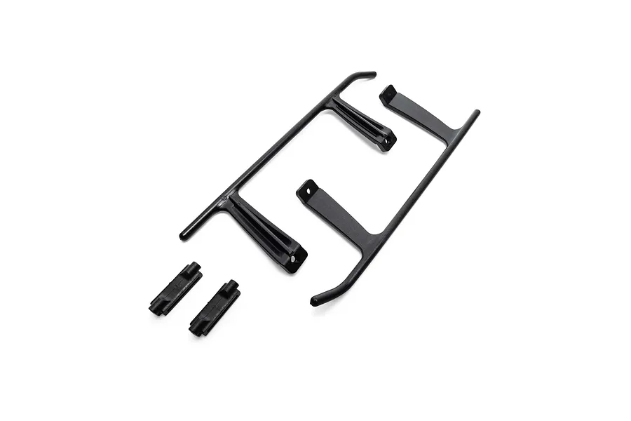 Blade black landing gear components and brackets for RC helicopters laid out on a white studio background.