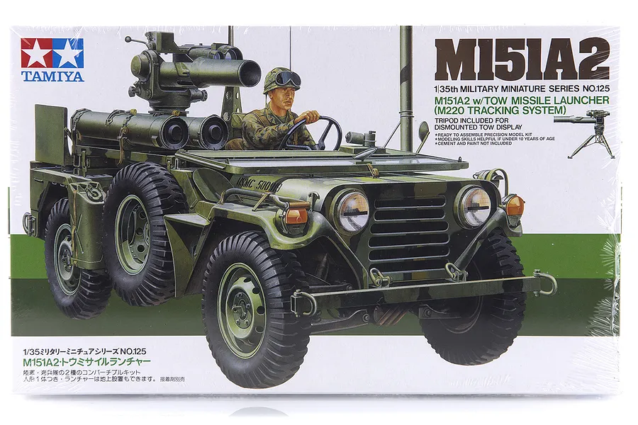 Tamiya 1/35 scale M151A2 with TOW missile launcher plastic model kit box art showing a US military vehicle with a soldier driver.