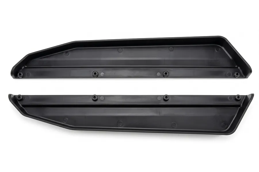Two black molded plastic chassis guards shown against a plain white background.