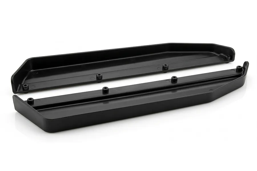 Two black molded plastic chassis guards displayed against a clean white background in a studio shot.