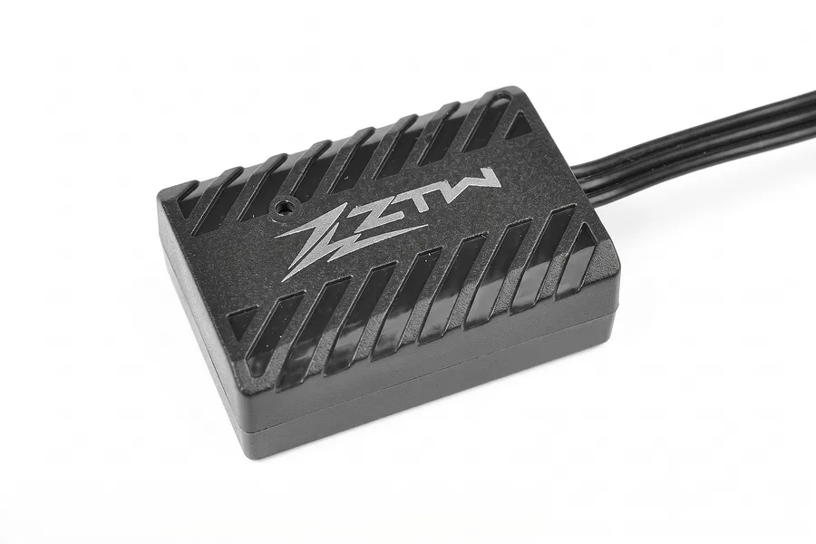 Studio product shot of a ZTW electronic module in a black plastic case with cooling fins and attached wires.