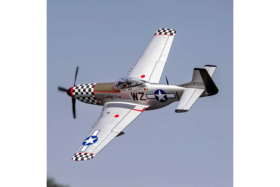 E-Flite P-51D Mustang Big Beautiful Doll RC plane in flight against a clear sky, showing silver fuselage and checkered nose.