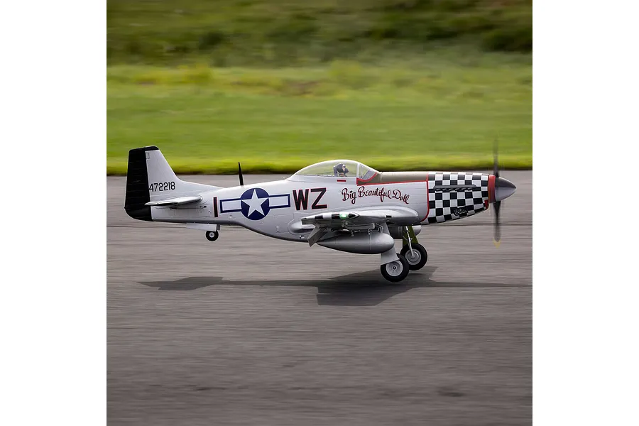 E-Flite P-51D Mustang Big Beautiful Doll RC fighter plane taxiing on an asphalt runway with green grass background.