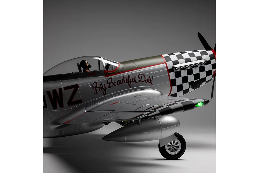 Close-up side profile of the E-Flite P-51D Mustang Big Beautiful Doll RC airplane showing the cockpit, pilot figure, and fuselage details.