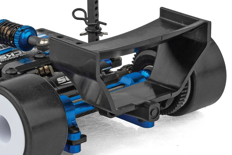 Close-up studio view of the rear wing, chassis, and suspension components of the Team Associated RC28F 1/28 scale RC car.