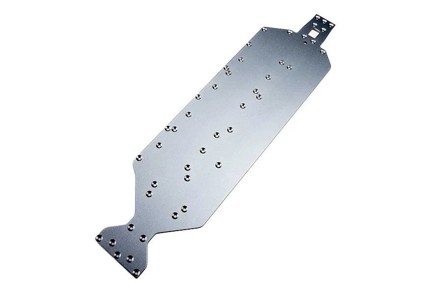Silver aluminium RC main chassis plate featuring multiple countersunk screw holes and cutouts against a white background.