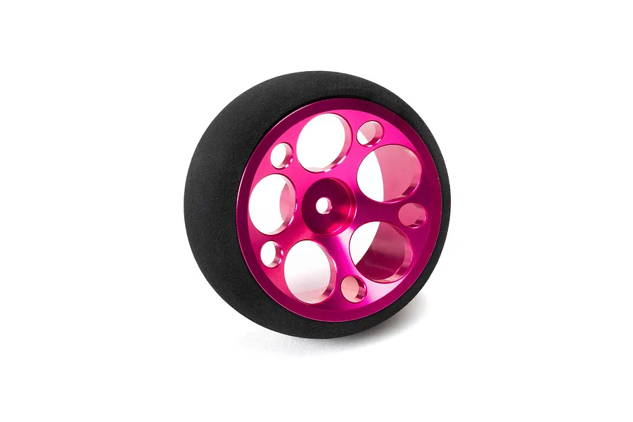 Pink aluminium wide circle transmitter wheel with black foam grip, isolated on a white studio background.