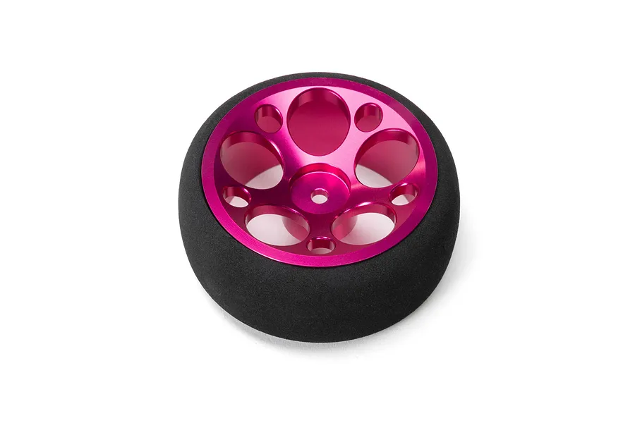 Spektrum aluminium wide circle wheel in pink with a black foam tyre against a white background.