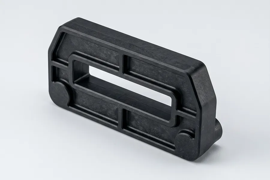 Black moulded plastic RC spare part with a central rectangular cutout and reinforced framing on a white background.