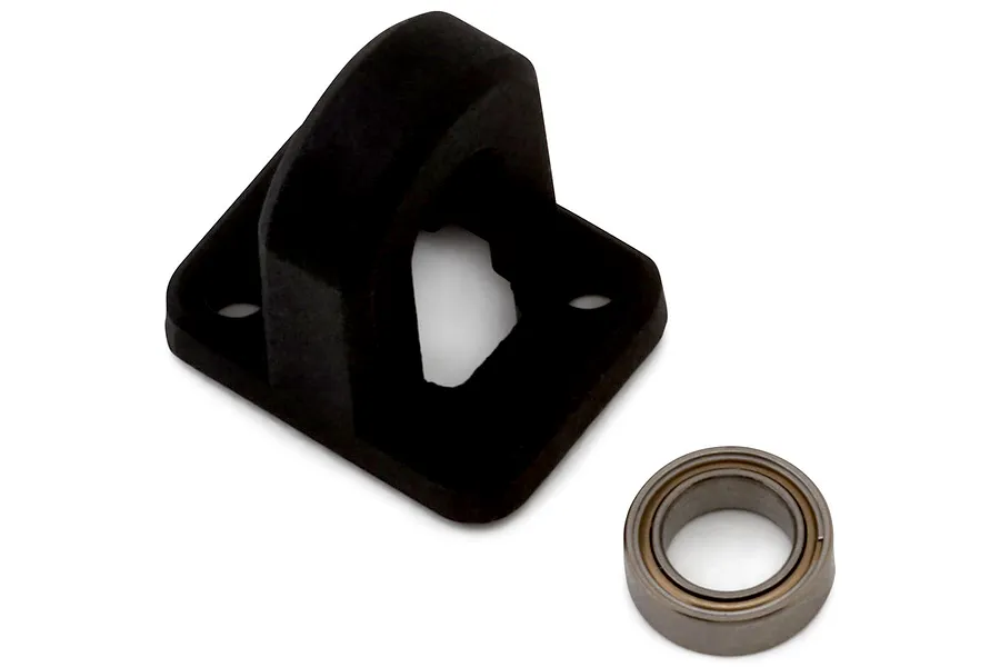 A black plastic centre driveshaft brace and a small metal ball bearing against a plain white background.