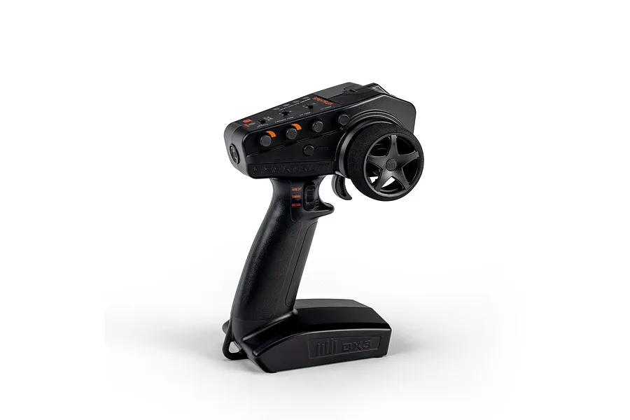 Spektrum DX3 Smart DSMR 2.4GHz RC transmitter in black on a white background, viewed from an angle showing controls and steering wheel.