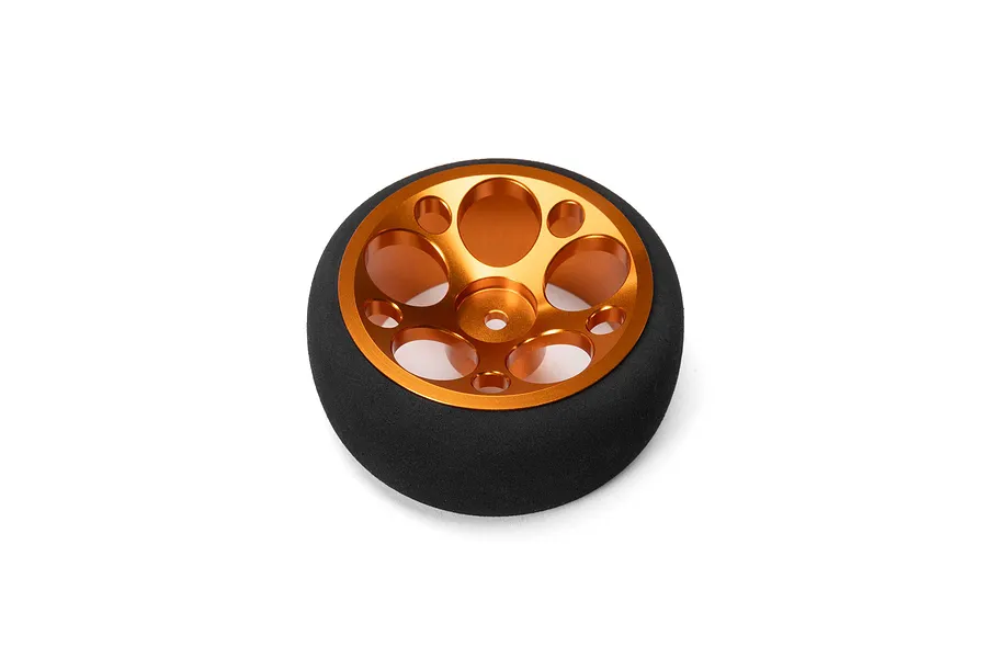 Spektrum aluminium wide circle transmitter wheel in orange with a black foam grip on a white background.