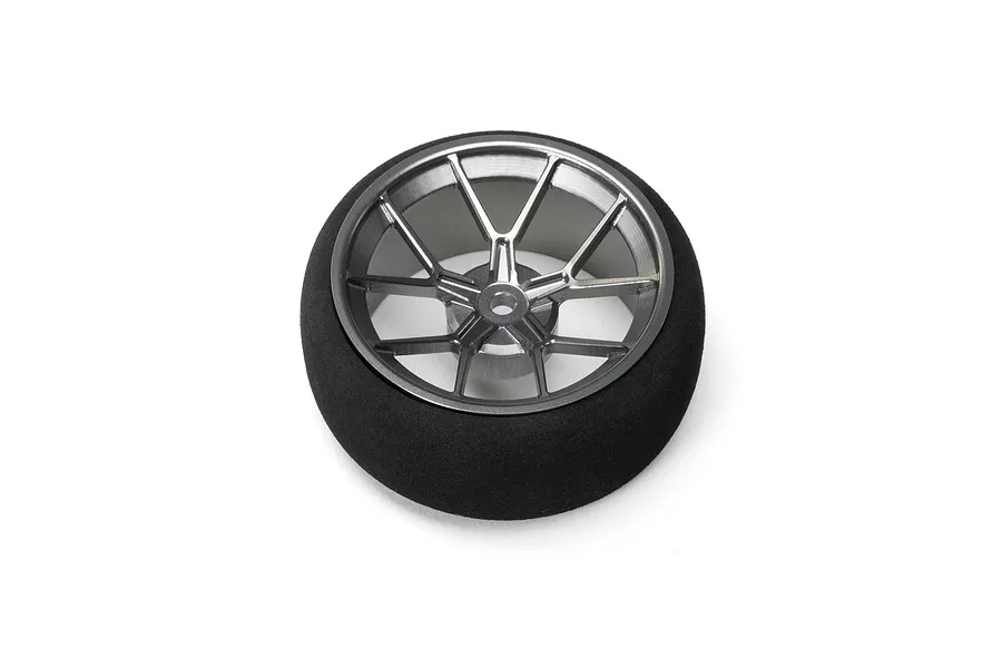 Spektrum Aluminium Wide Spoke Transmitter Wheel in gunmetal grey with a black foam grip, viewed from the front against a white background.