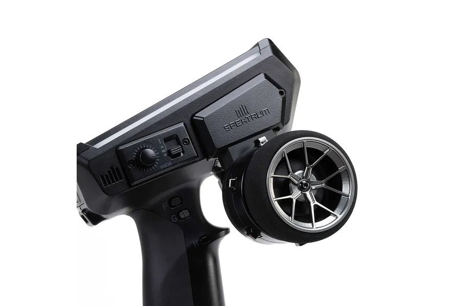 Spektrum aluminium wide spoke transmitter wheel installed on a black RC radio controller against a white background.