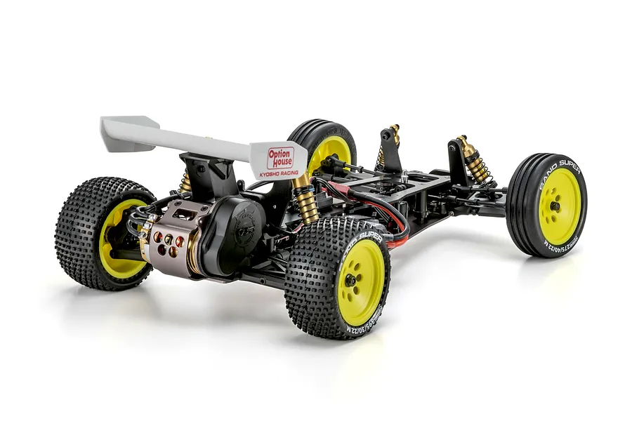 Rear-three-quarter view of the Kyosho Ultima Pro 1/10 electric 2WD RC buggy kit chassis featuring yellow wheels and Option House wing branding.