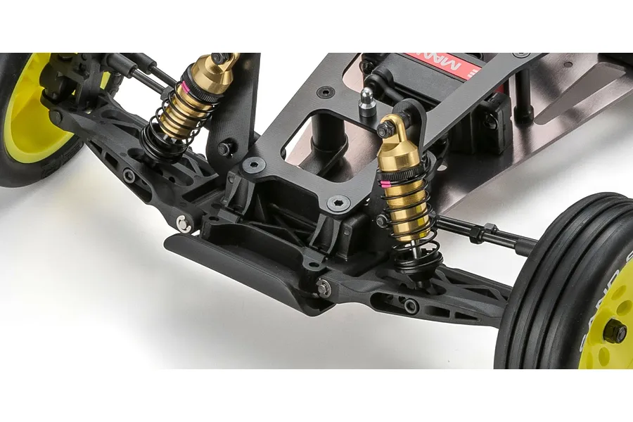 Close-up studio shot of the front suspension, gold shock absorbers, chassis, and yellow wheels on an RC buggy.