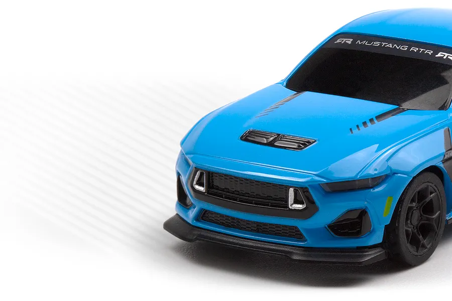 Close-up of the front quarter of a blue HPI Nano-TTR Ford Mustang RC car on a white background.