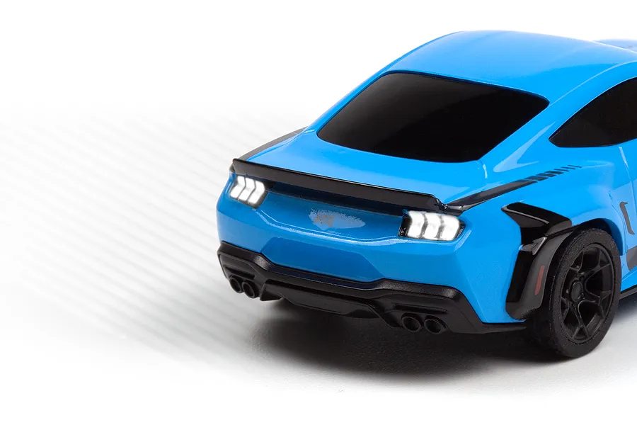 Close-up of the rear end of a blue HPI Nano-TTR Ford Mustang Spec 5 RC car, showing illuminated taillights and quad exhaust tips.
