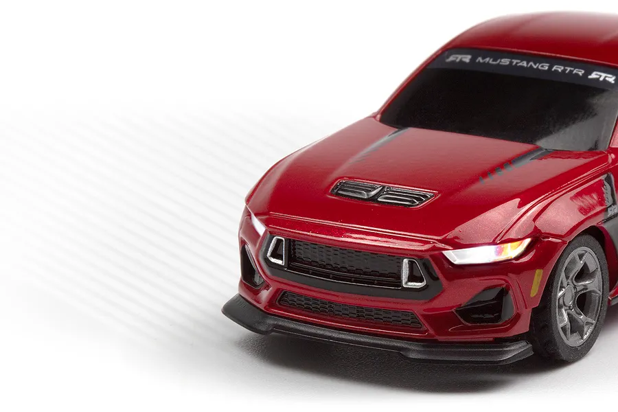 Close-up studio shot of the front-left section of the red HPI Nano-TTR Ford Mustang RC car with lit headlights.