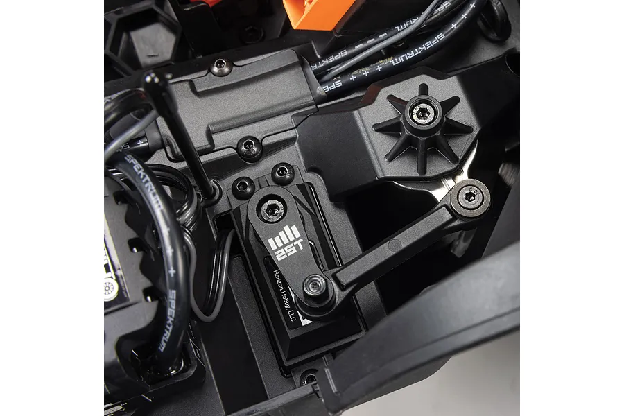 Close-up studio view of the steering servo, linkage, and receiver box inside an ARRMA 4S RC monster truck chassis.