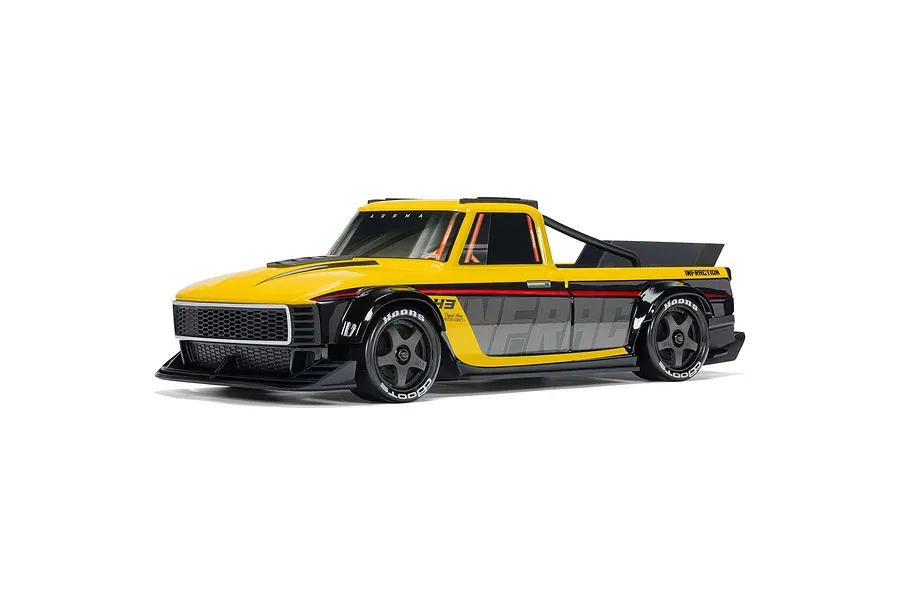 ARRMA Infraction Grom 3S yellow and black RC street truck in studio setting, angled front three-quarters view.
