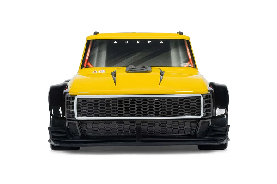 Front view of the yellow ARRMA Infraction Grom 3S RC car body, highlighting the front grille and tinted windshield.