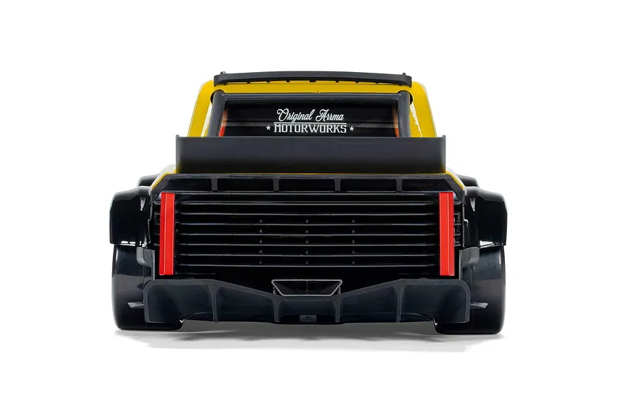Rear view of the ARRMA Infraction Grom 3S RC car in yellow, showing rear diffuser and Original Arrma Motorworks window decal.