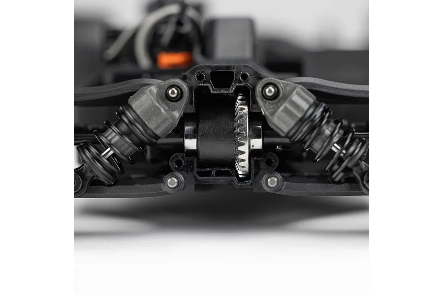 Close-up of the internal gear differential and suspension shock absorbers on the chassis of an ARRMA RC car.