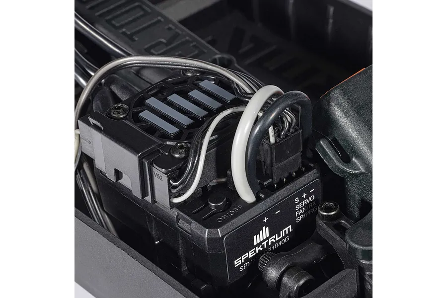 Close-up of the internal electronic speed controller and receiver unit with wires installed inside the ARRMA Infraction Grom chassis.