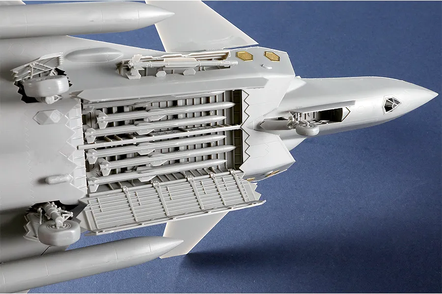 Underside view of the Trumpeter 1/48 Chinese J-20S Mighty Dragon model kit showing open weapon bays loaded with missiles and landing gear deployed.