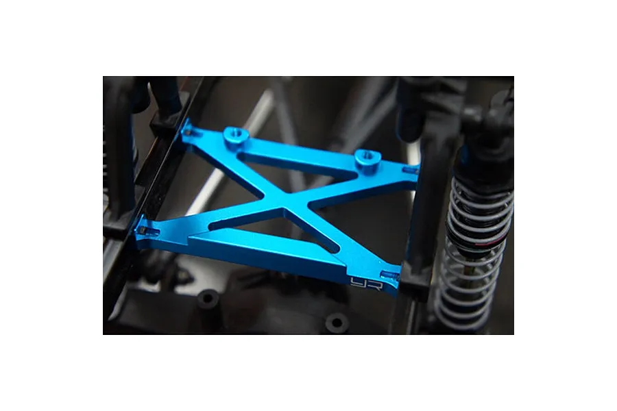 Yeah Racing blue aluminium rear H brace installed on an RC car chassis near suspension components.