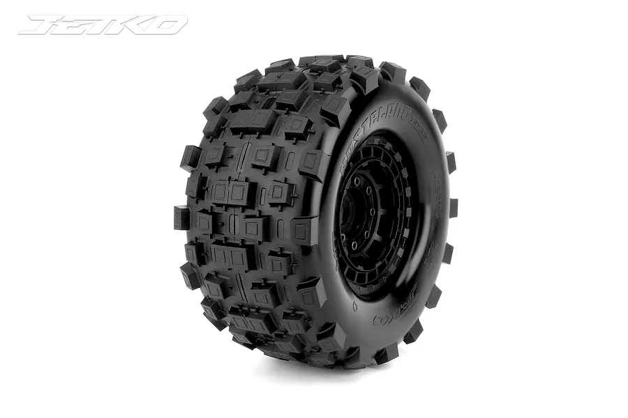 Jetko Ex-Wasteland XMT belted RC monster truck tyre mounted on a black claw rim against a white background.