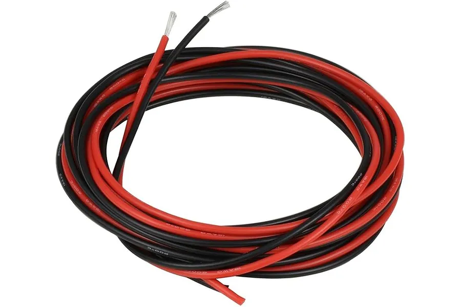 Coiled red and black silicone wire featuring exposed stripped copper ends against a plain white background.