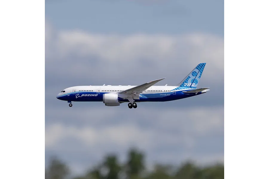 E-Flite Micro Boeing 787 Dreamliner RC airplane in flight against a blue sky background.