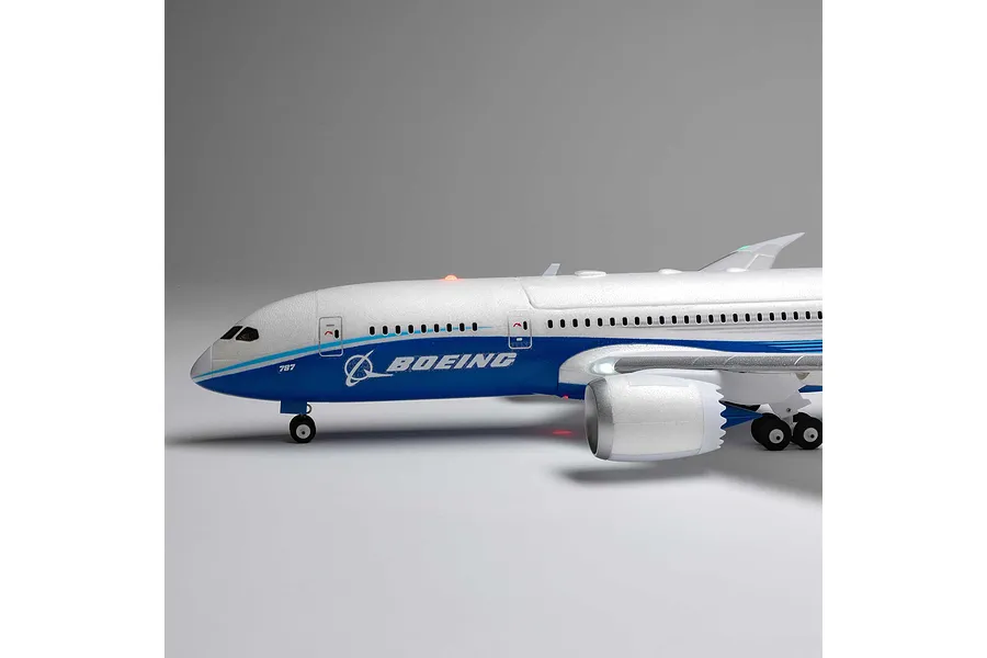 Close-up side profile of the E-Flite Boeing 787 Dreamliner RC plane showing cockpit windows, fuselage, and engine nacelle.