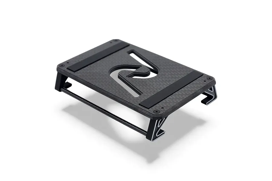 INOV8 1/10 carbon fibre car stand in black and silver against a white background.