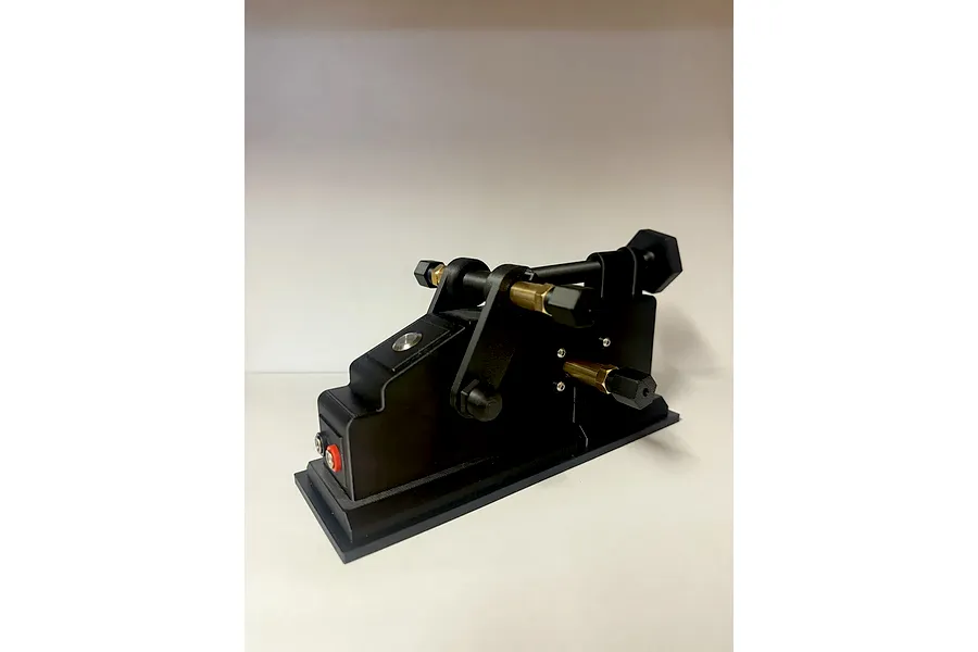Black TK Racing Tyre Prep and Break In Machine viewed from an angle against a plain white background.