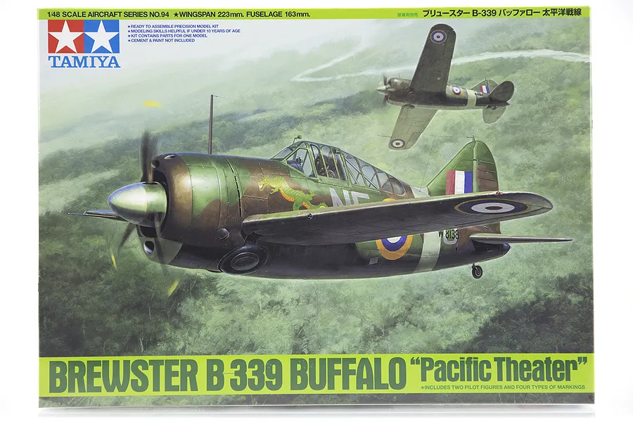 Tamiya 1/48 scale Brewster B-339 Buffalo Pacific Theater model kit box art showing two fighter planes flying over a jungle landscape.