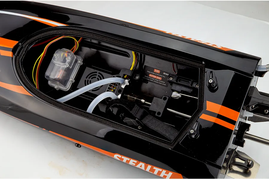 Interior hull view of the Atrek Stealth 25 brushless RC speed boat showing electronics, wiring, and water cooling lines.