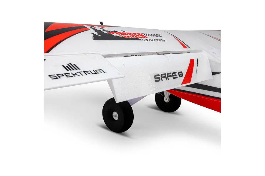 Close-up of the landing gear, wing, and flaps on the E-Flite Turbo Timber Evolution RC plane against a white background.
