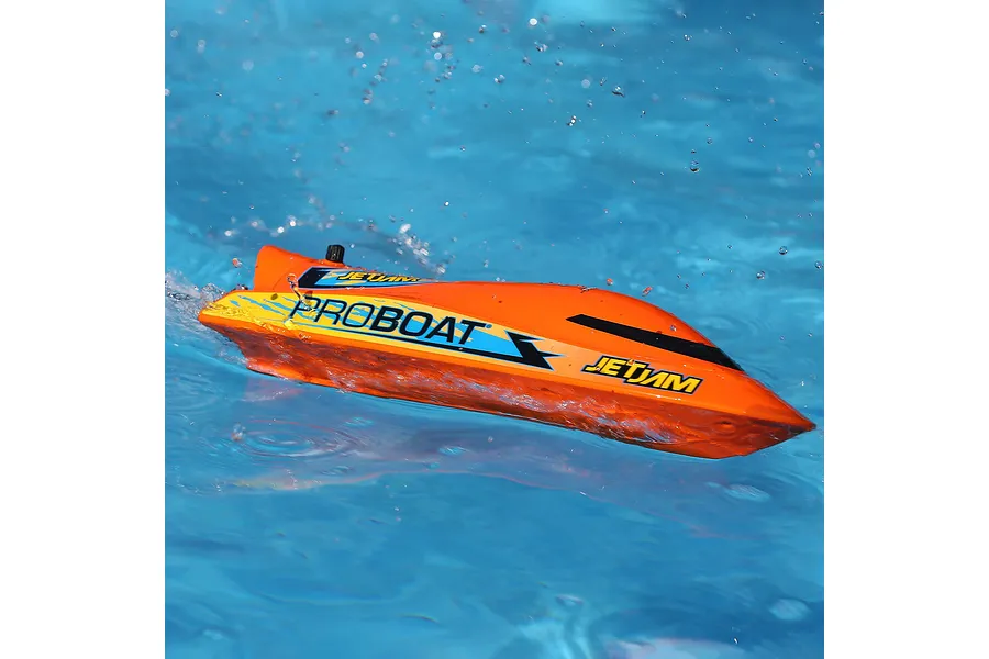 Pro Boat Jet Jam V2 electric RC speed boat in orange running on water with splashes surrounding it.