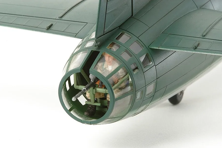 Close-up of the nose section of a Tamiya 1/48 Mitsubishi G4M1 model aircraft, showing the cockpit, gunner, and machine gun.