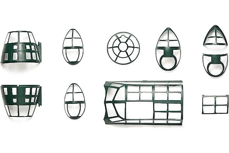 A collection of dark green plastic model aircraft canopy and window parts for a Tamiya 1/48 Mitsubishi G4M1 model kit, arranged on a white background.