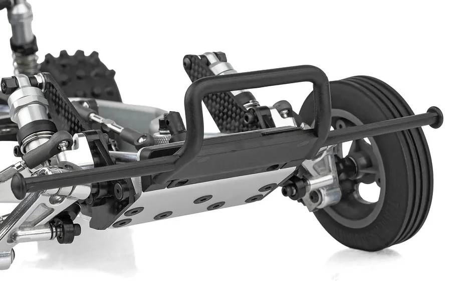 Close-up of the front bumper, chassis plate, and suspension components of the Team Associated RC10 Ultra Rider buggy.